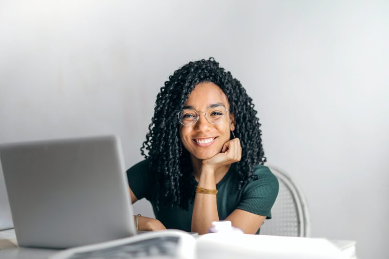 Smiling woman in front of a laptop computer