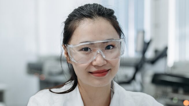 Close-up of female lab scientist with safety glasses in laboratory celebrating Lab Week
