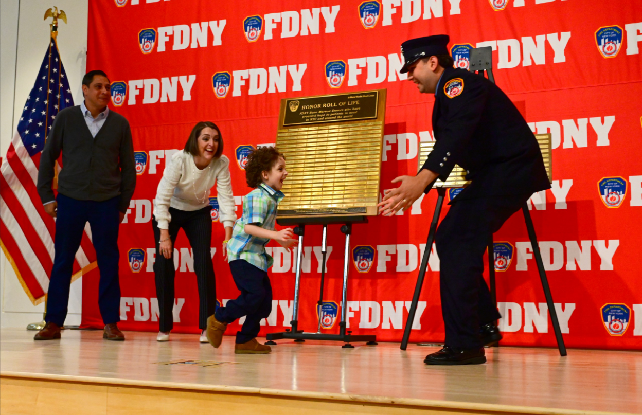Five-year-old f Cristiano Frigoli runs to embrace his blood marrow donor, FDNY firefighter Ryan McLean.