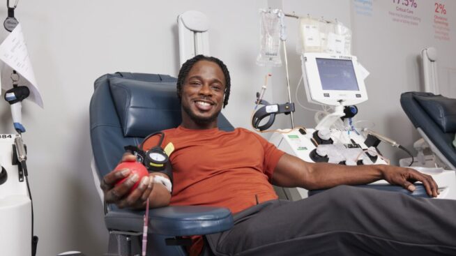 Smiling blood donor giving blood at New York Blood Center