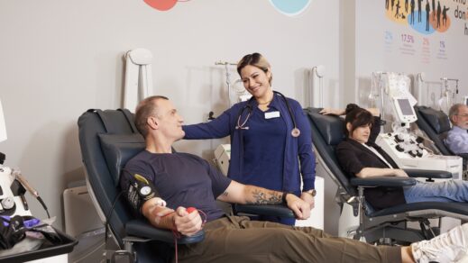 RIBC Phlebotomist laughing with blood donor reclining in a donor chair