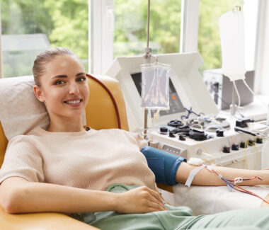 Smiling woman donating blood at a New York Blood Center donation location.