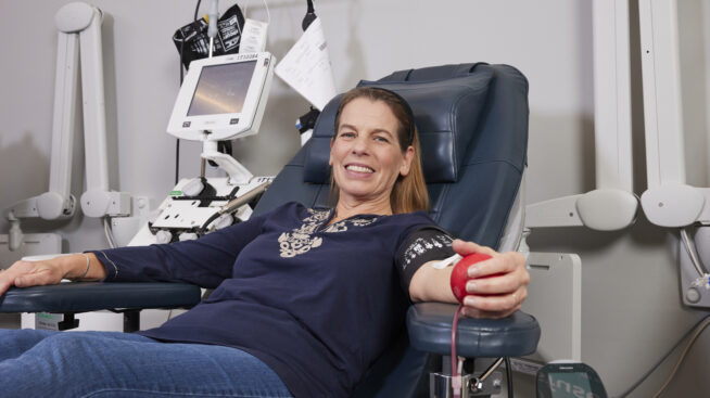 Smiling blood donor in donation chair at CTBC donation location.