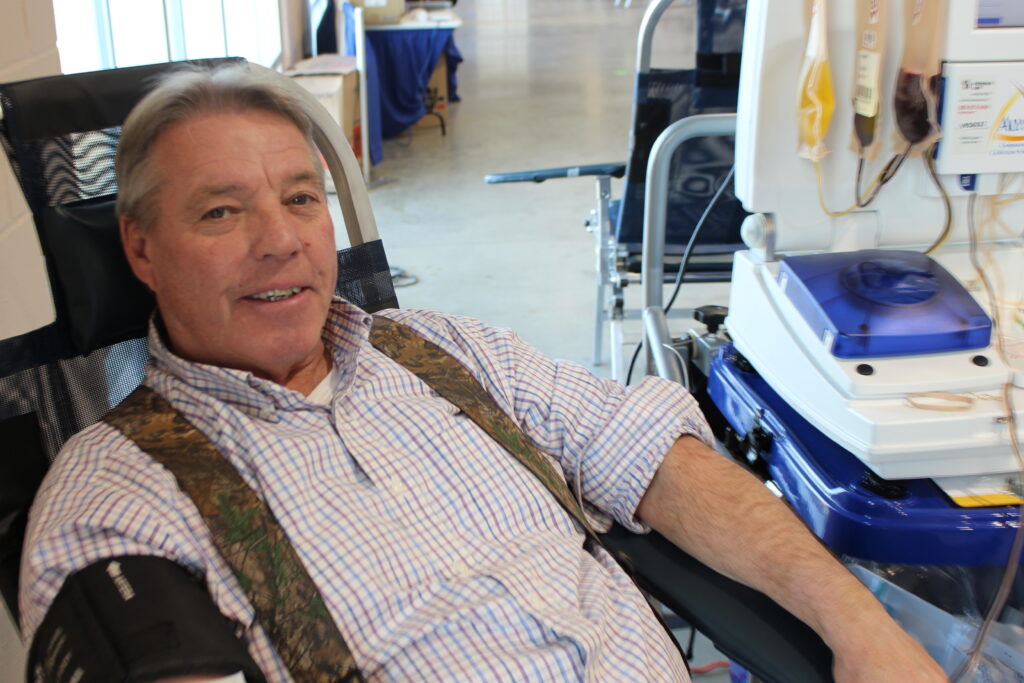 A smiling donor giving blood.