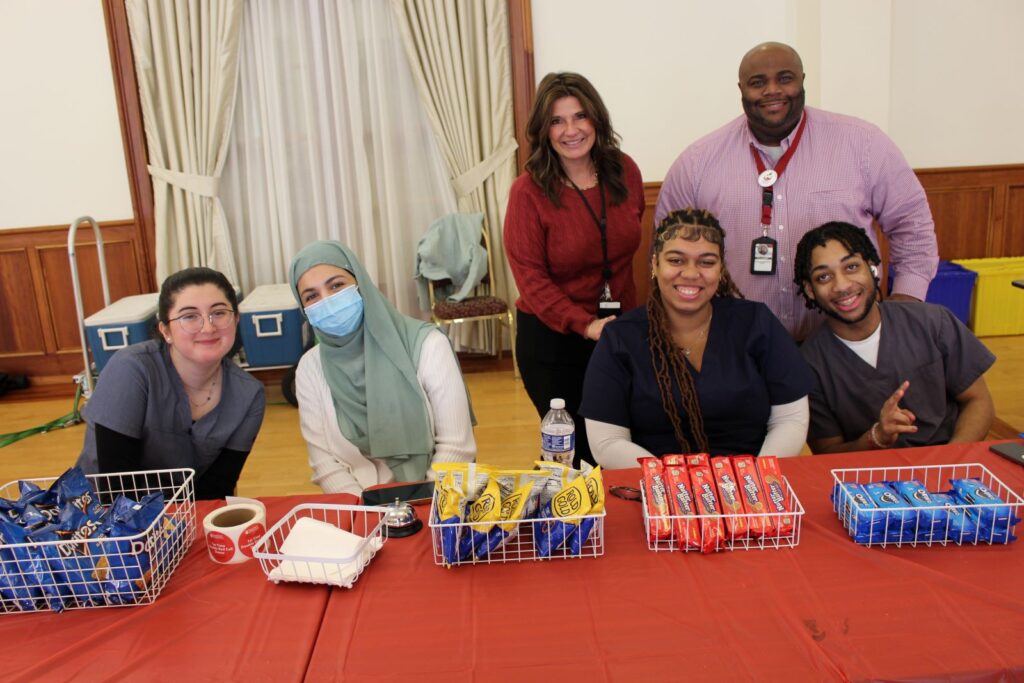 Students from Appoquinimink, Middletown and Odessa high schools smiling with blood drive snacks.