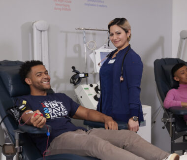 BBD phlebotomist with blood donor in donation chair