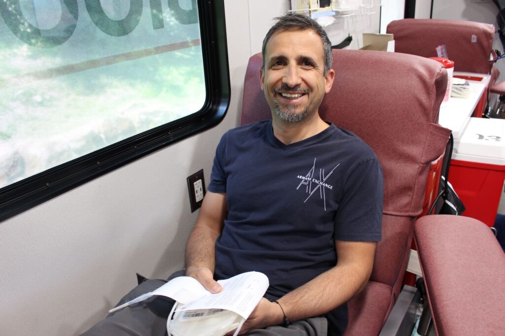 Blood donor smiling in the donation chair at the Wilmington Brew Works blood drive.