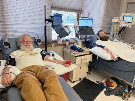 Henry and Fred Zander sit side by side donating platelets,