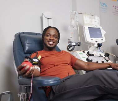 Smiling blood donor in donation chair at MBC location.